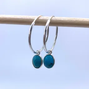 Gemstone earrings with turquoise (blue) oval crystal drops on silver medium hoops